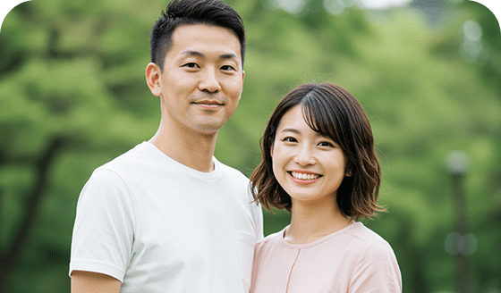 笑顔で肩を寄せ合うカップルの写真